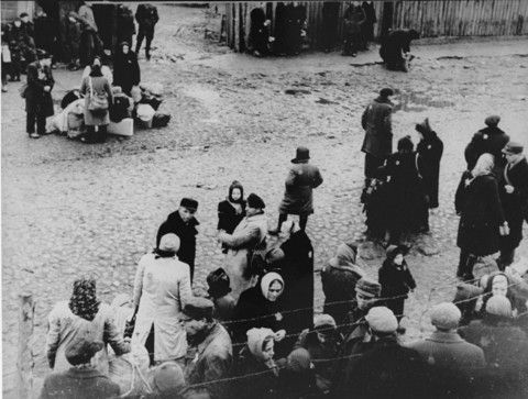 Jews are gathered at an assembly point in the Kovno ghetto during a deportation action to Estonia